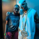 A Man And Boy Posing For The Camera.